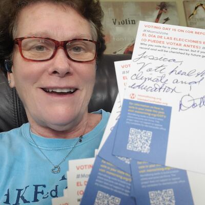 A MomsRising volunteer with handwritten postcards