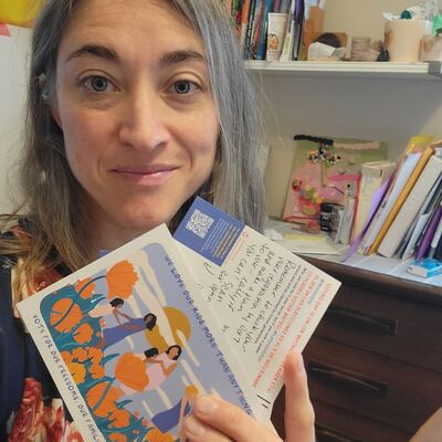 A MomsRising volunteer with handwritten postcards
