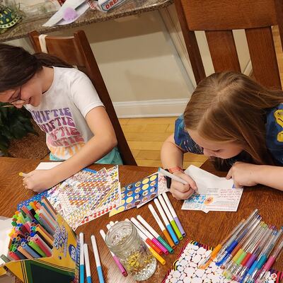 A MomsRising volunteer with handwritten postcards