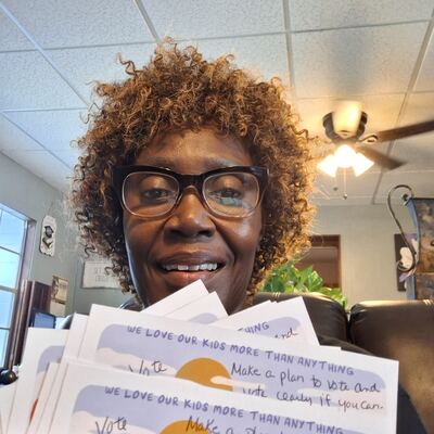 A MomsRising volunteer with handwritten postcards