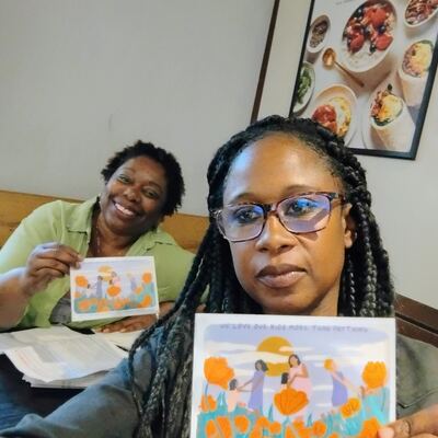A MomsRising volunteer with handwritten postcards