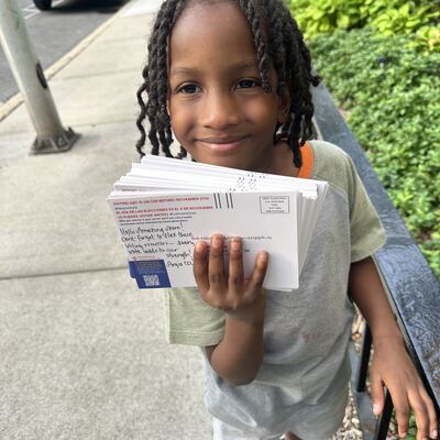 A MomsRising volunteer with handwritten postcards