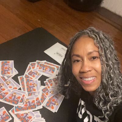 A MomsRising volunteer with handwritten postcards