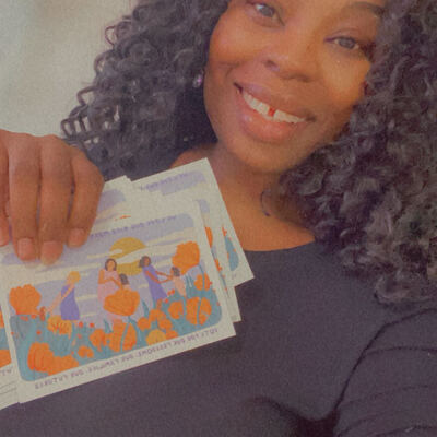 A MomsRising volunteer with handwritten postcards