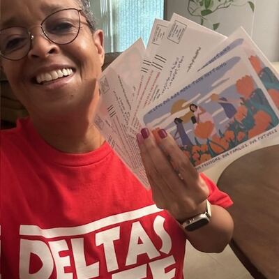 A MomsRising volunteer with handwritten postcards