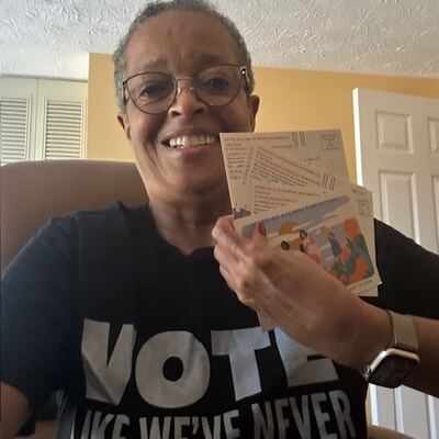 A MomsRising volunteer with handwritten postcards