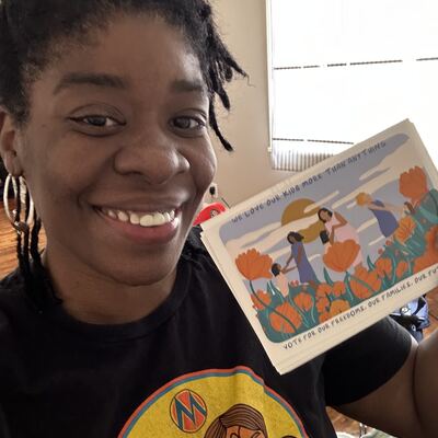 A MomsRising volunteer with handwritten postcards