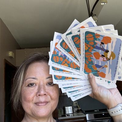A MomsRising volunteer with handwritten postcards