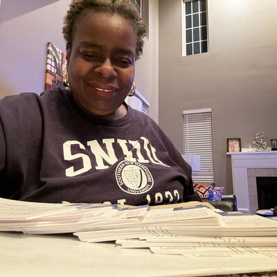 A MomsRising volunteer with handwritten postcards