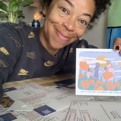 A MomsRising volunteer with handwritten postcards