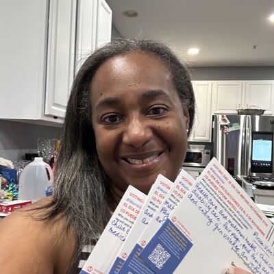 A MomsRising volunteer with handwritten postcards