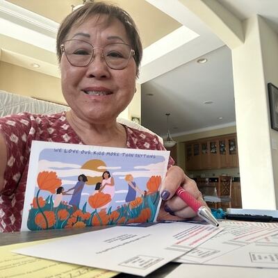 A MomsRising volunteer with handwritten postcards