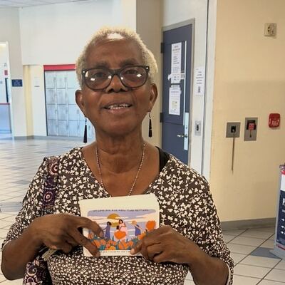 A MomsRising volunteer with handwritten postcards