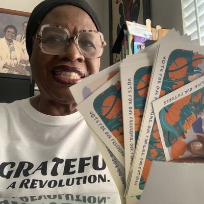 A MomsRising volunteer with handwritten postcards