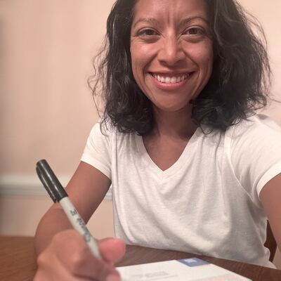 A MomsRising volunteer with handwritten postcards