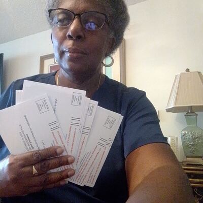 A MomsRising volunteer with handwritten postcards