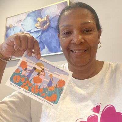 A MomsRising volunteer with handwritten postcards