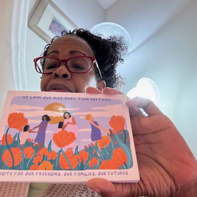 A MomsRising volunteer with handwritten postcards