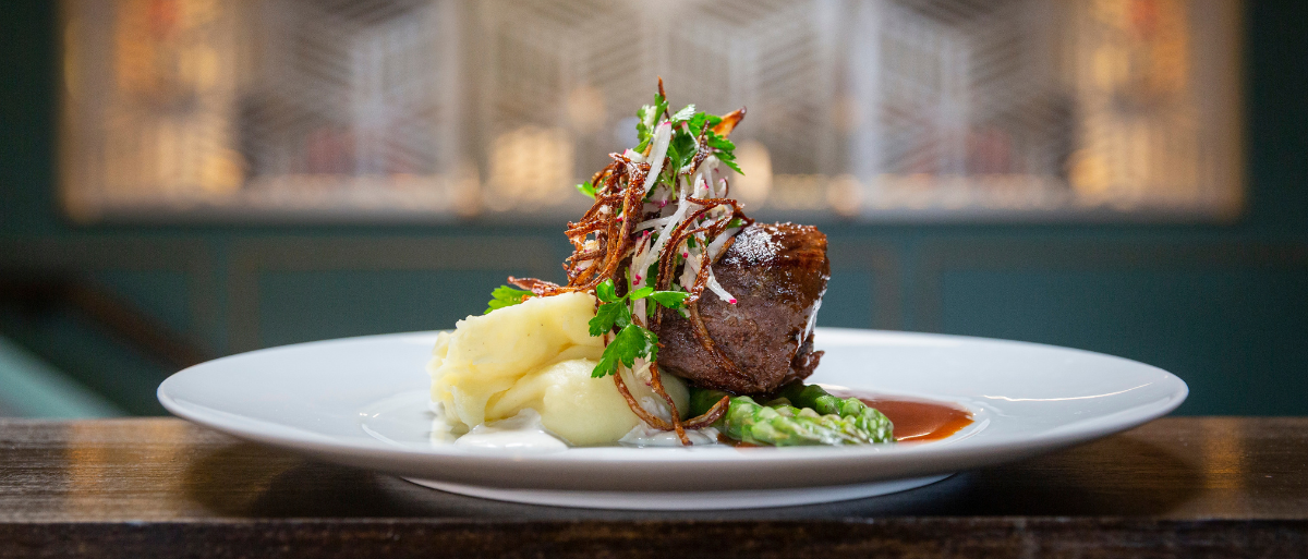 A plated entrée at a Looking Glass Hospitality restaurant