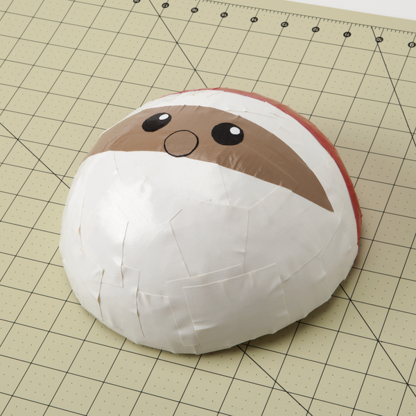 Top portion of the dome covered in red to create the base of his hat