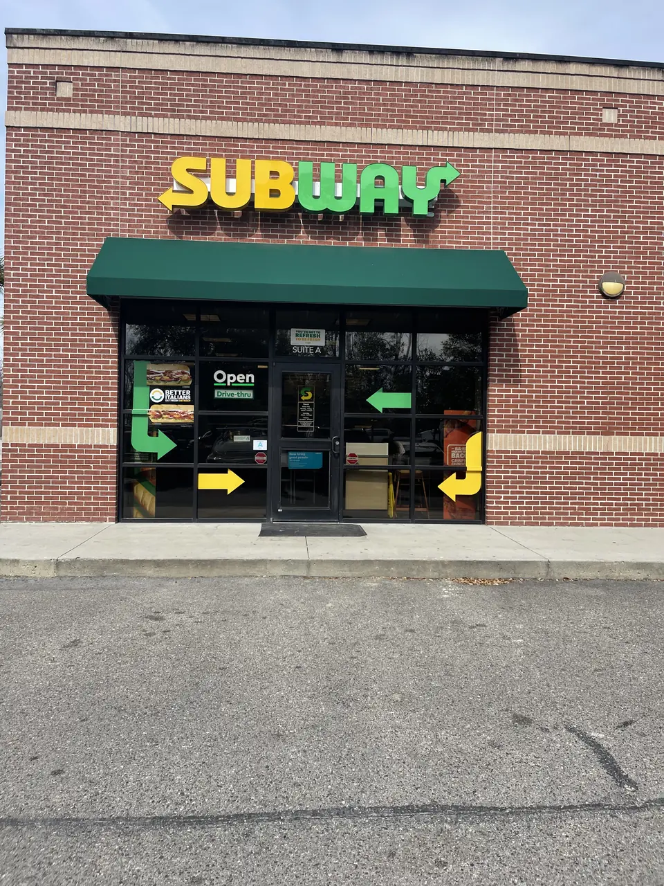 Subway restaurant lighted sign above the main storefront entrance.