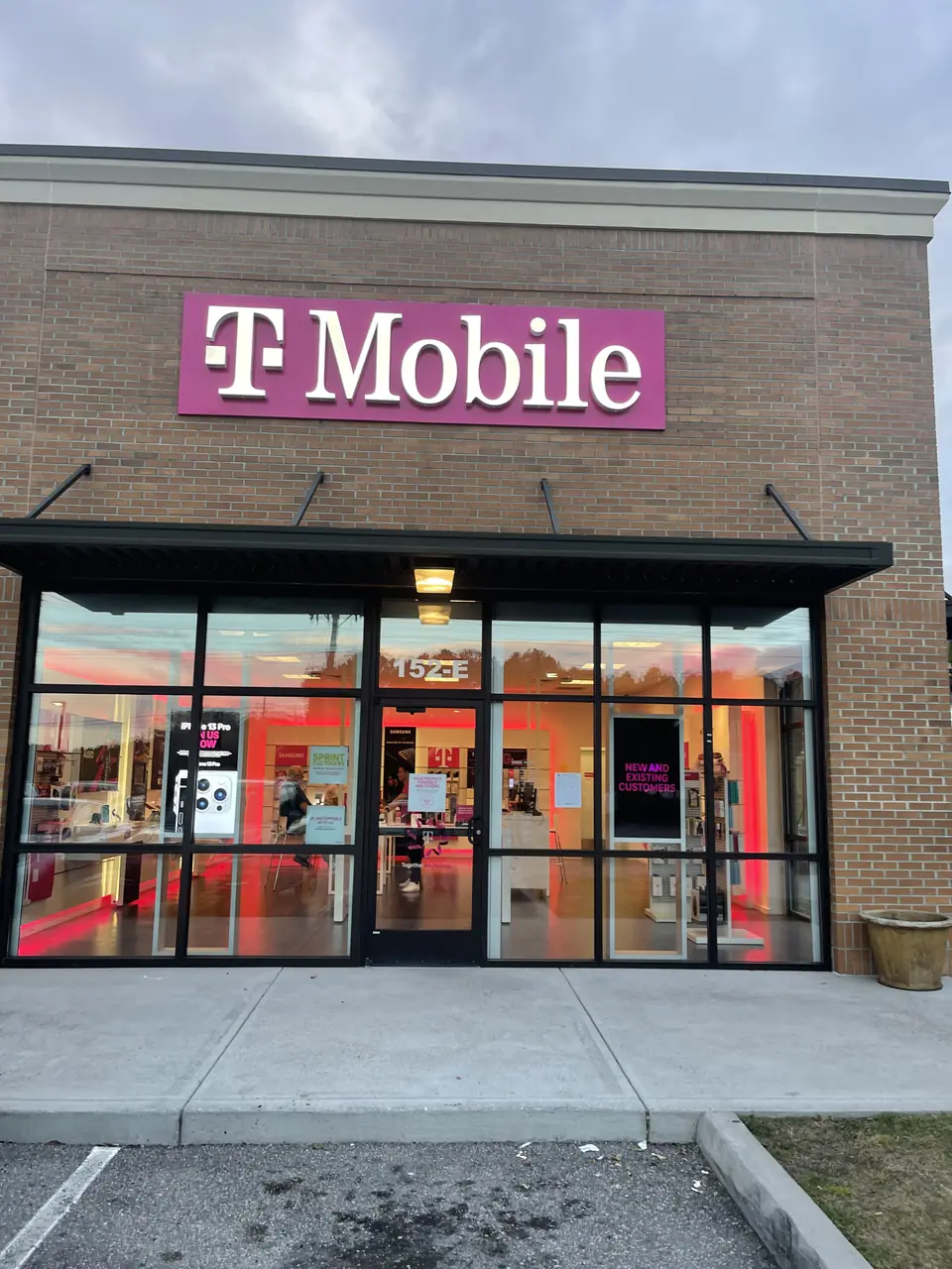 T-Mobile storefront sign with illuminated magenta cabinet mounted above the entrance.