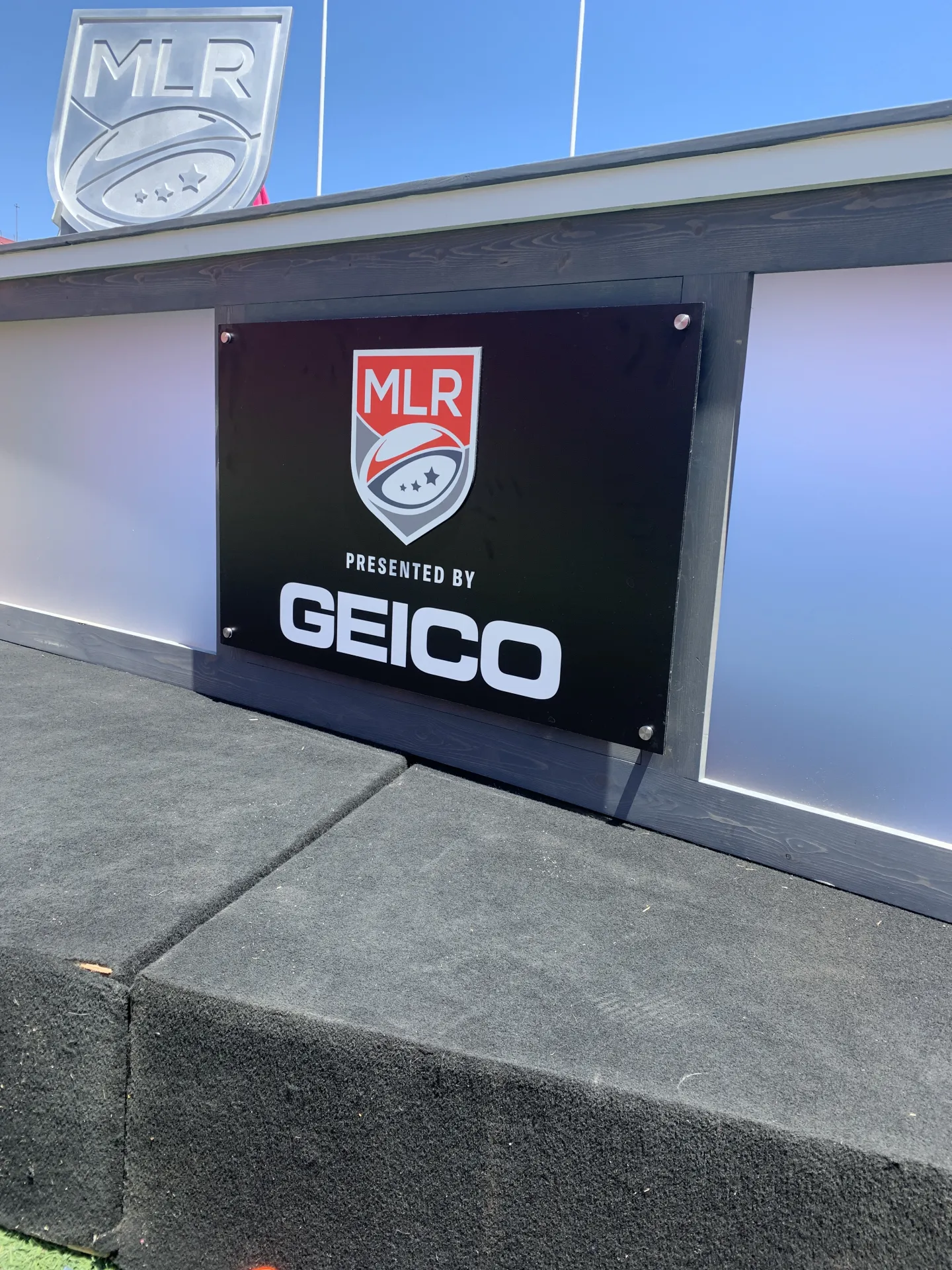 Close up shot of desk and sign with stand offs, showing precise spacing and clean reflections on the face.