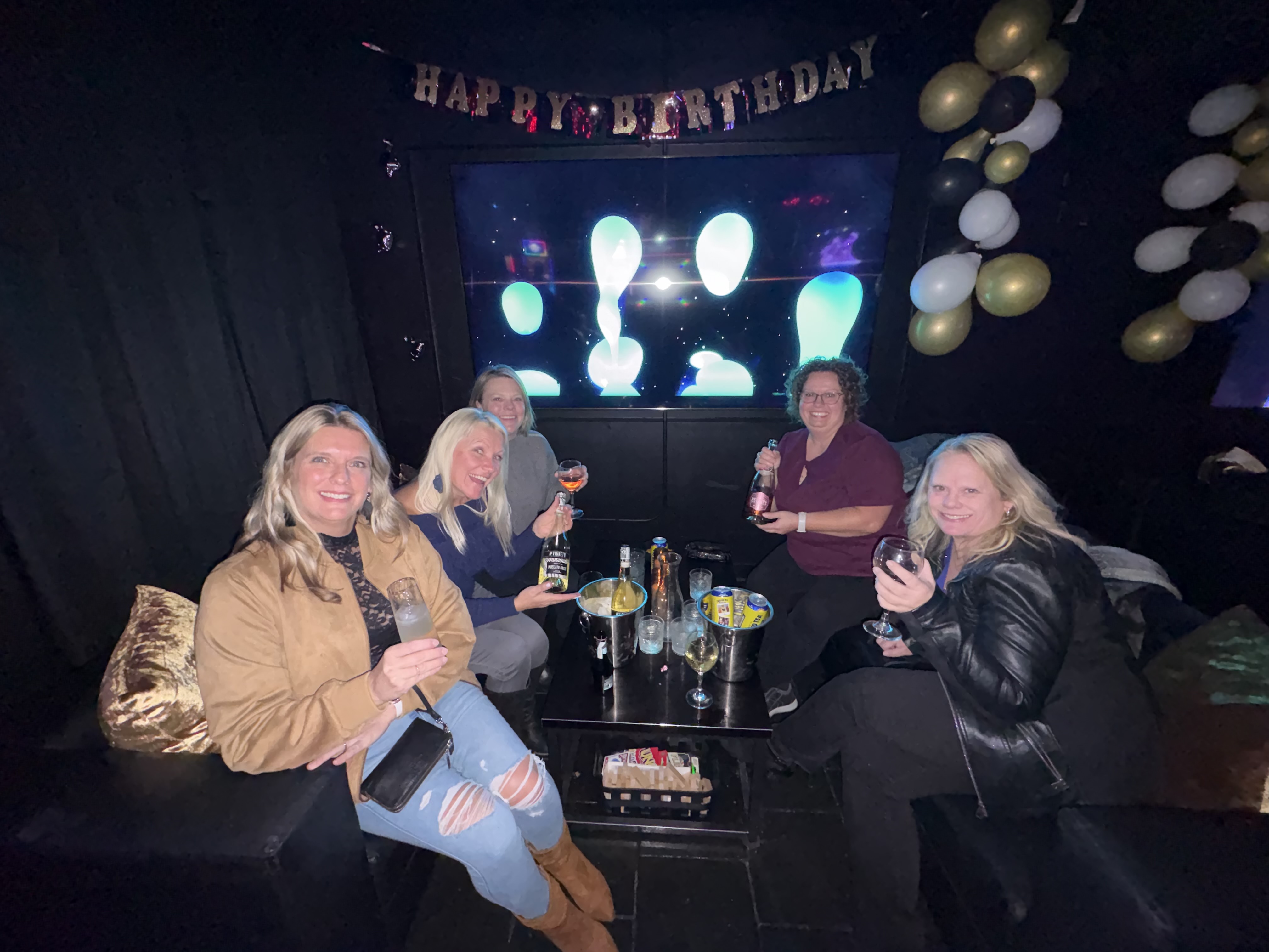 Friends celebrating a birthday in a private booth