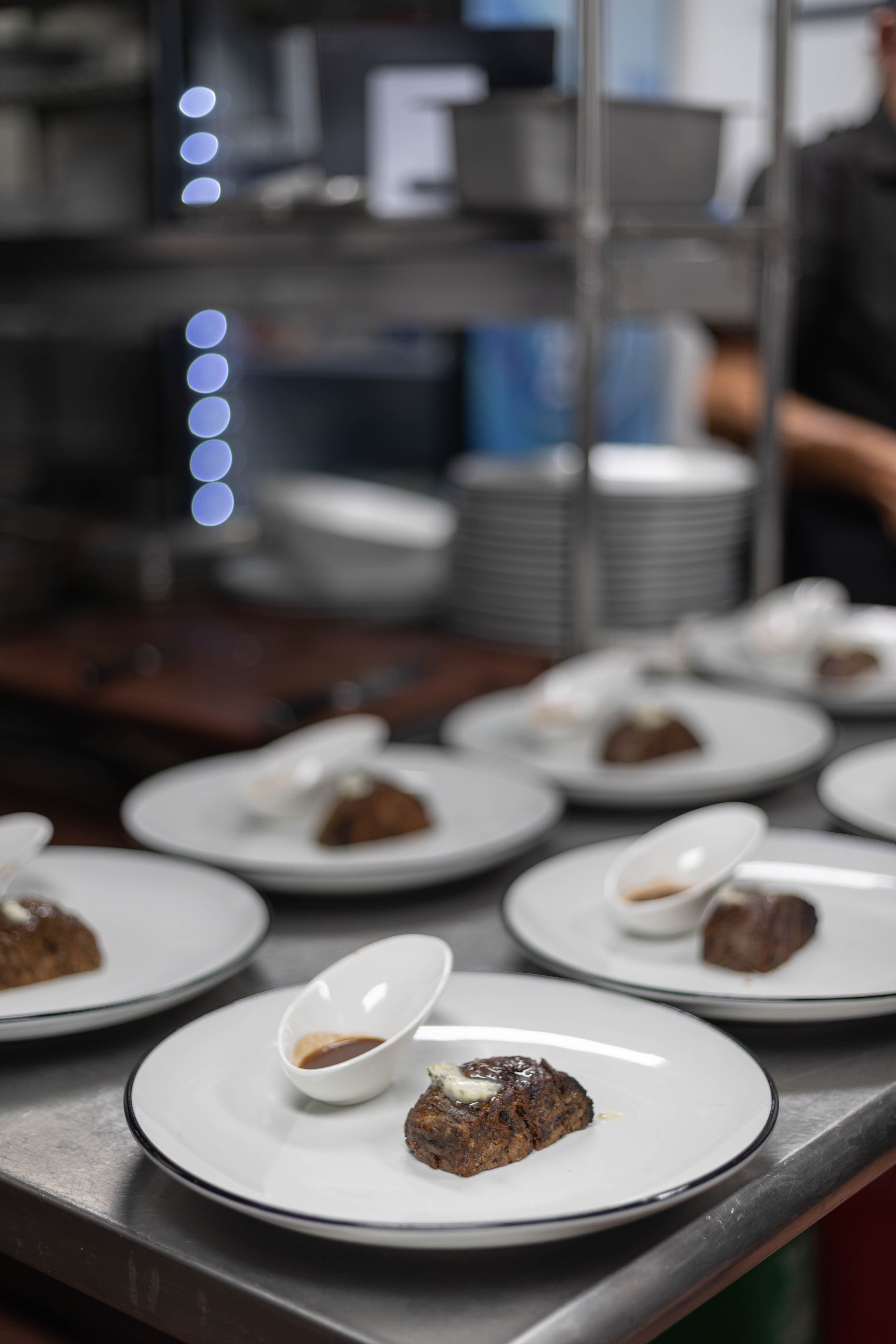 Chophouse kitchen plating steaks for a group