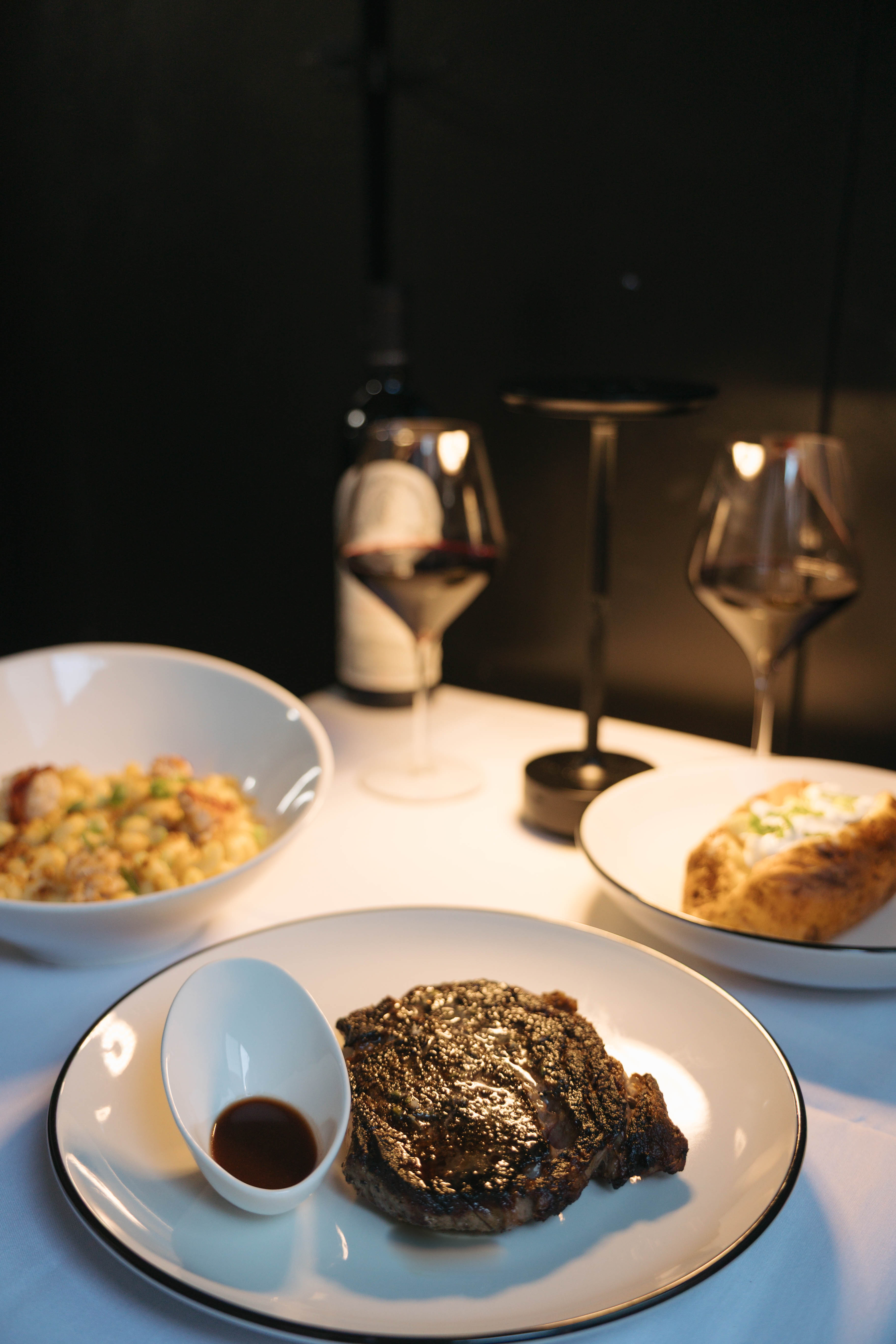 Steak with mac and cheese and baked potato