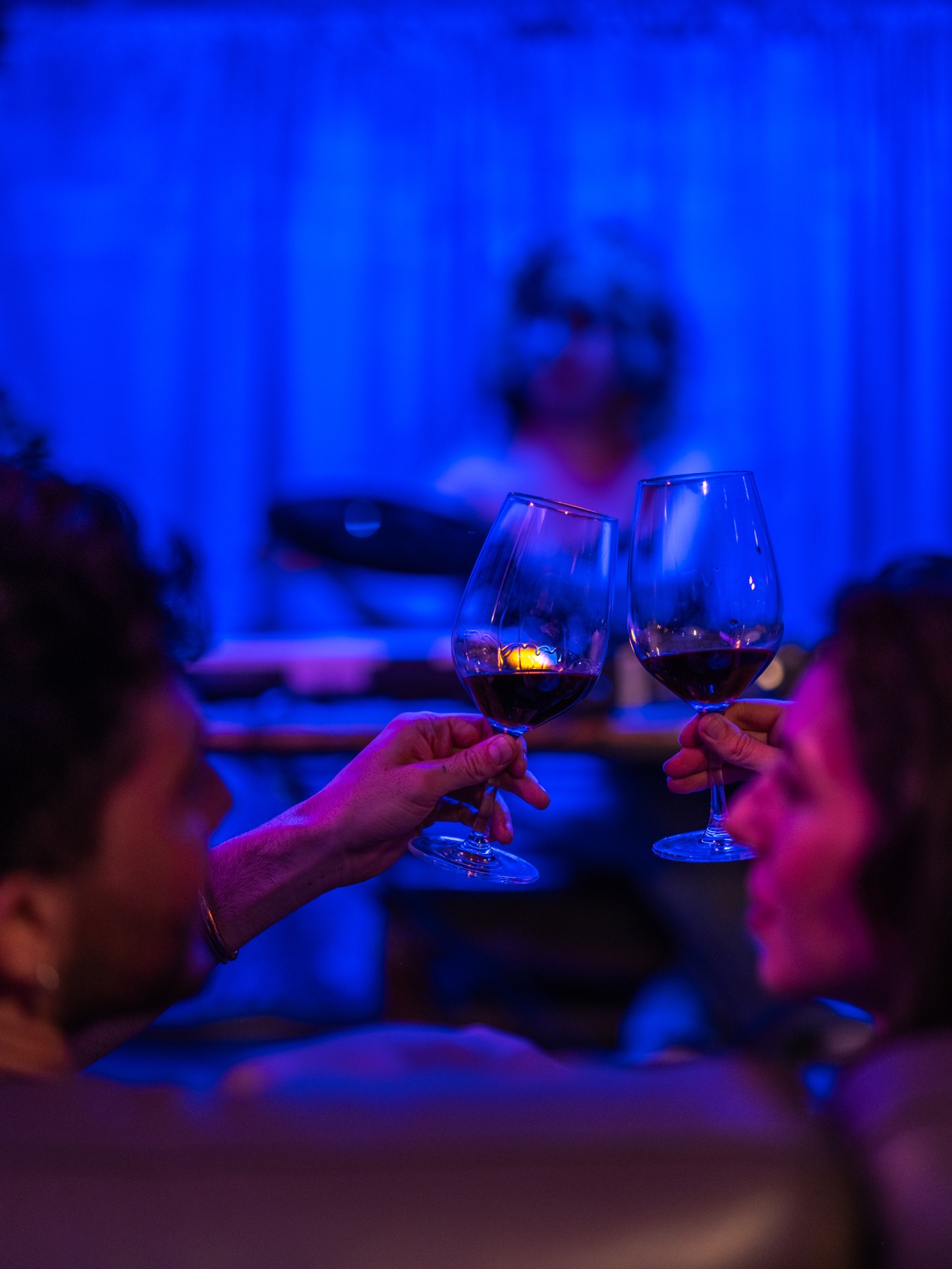 Two glasses of red wine raised in the listening room