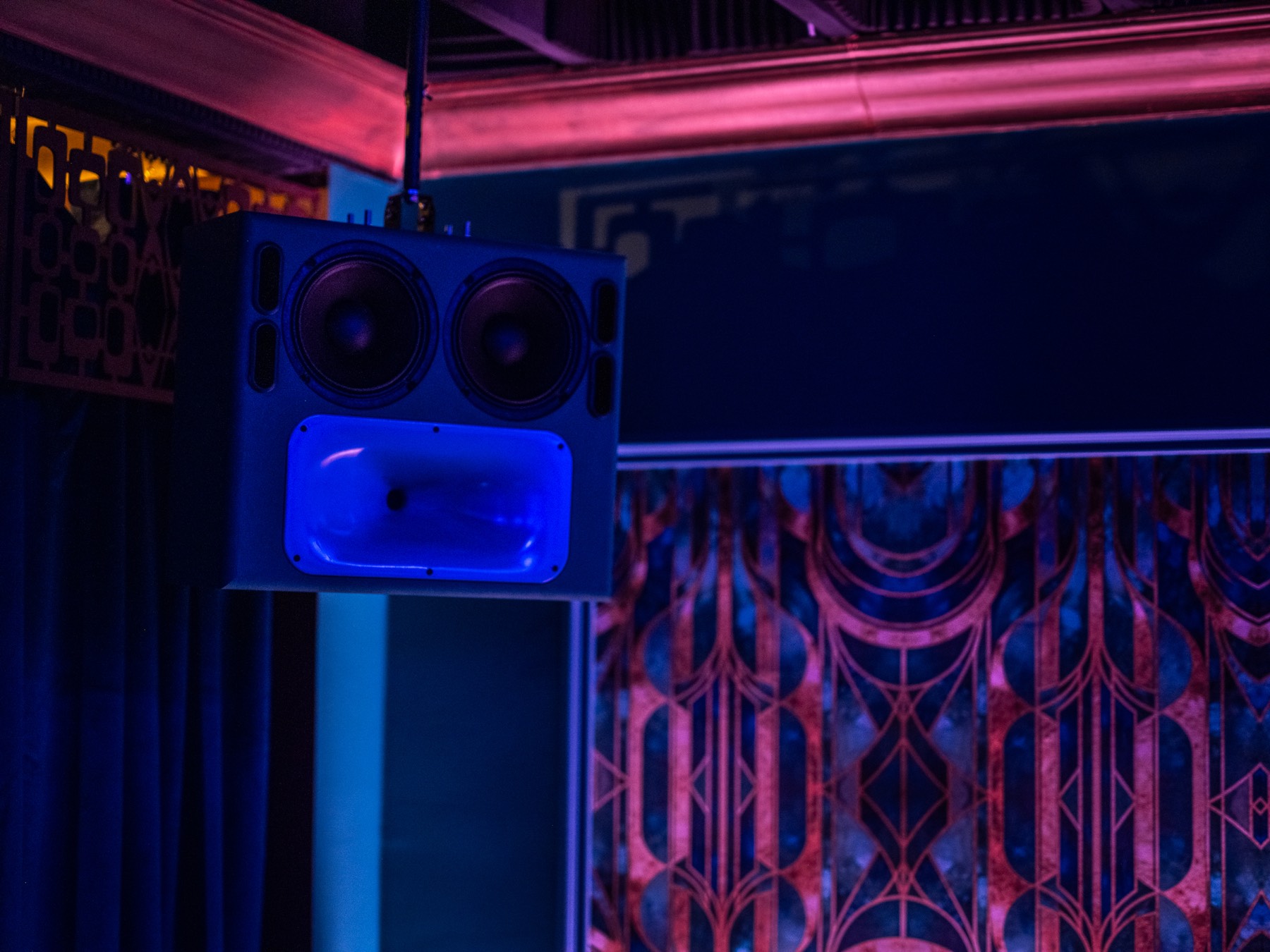 A horn speaker above the art deco wall