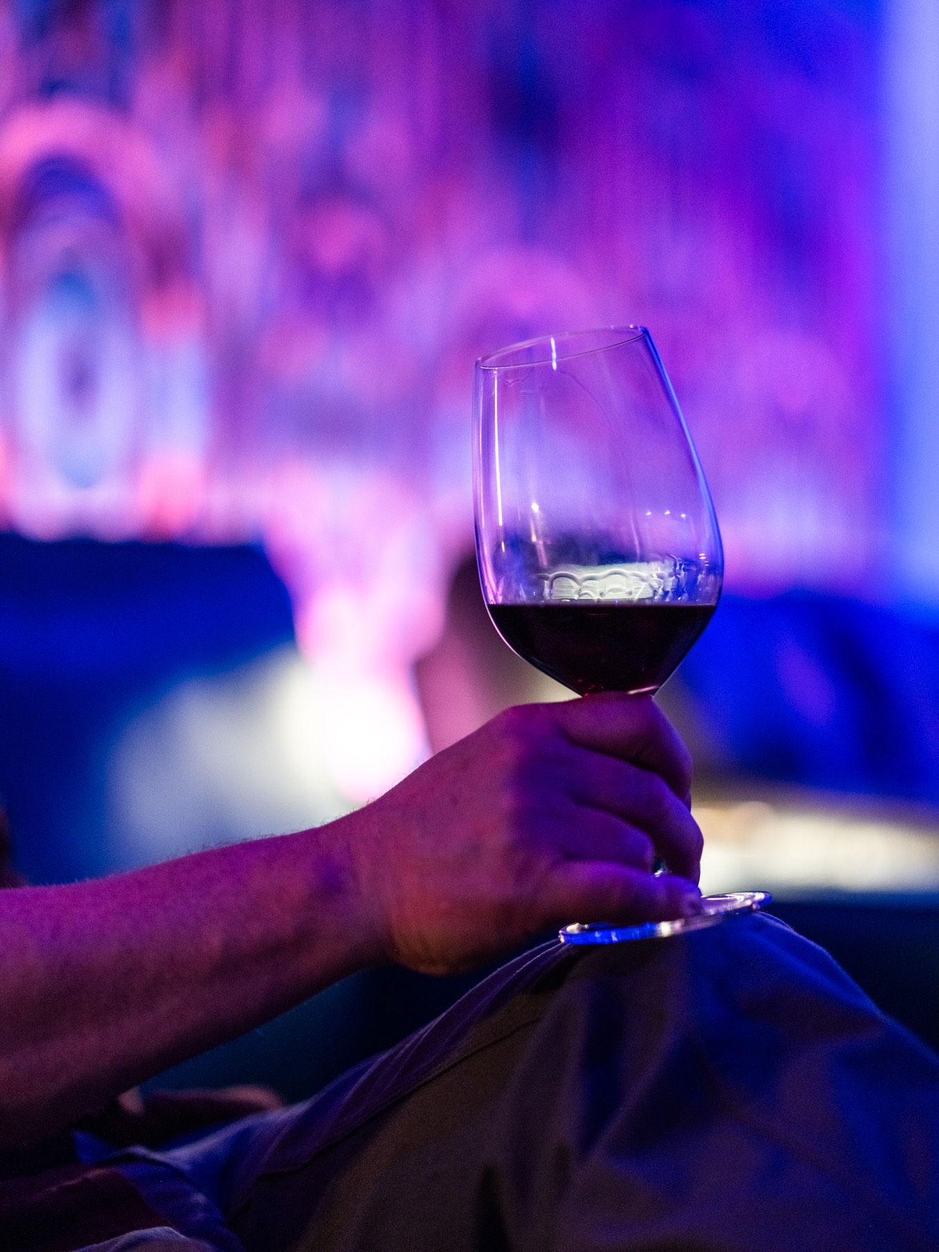 A glass of red wine held in the lounge