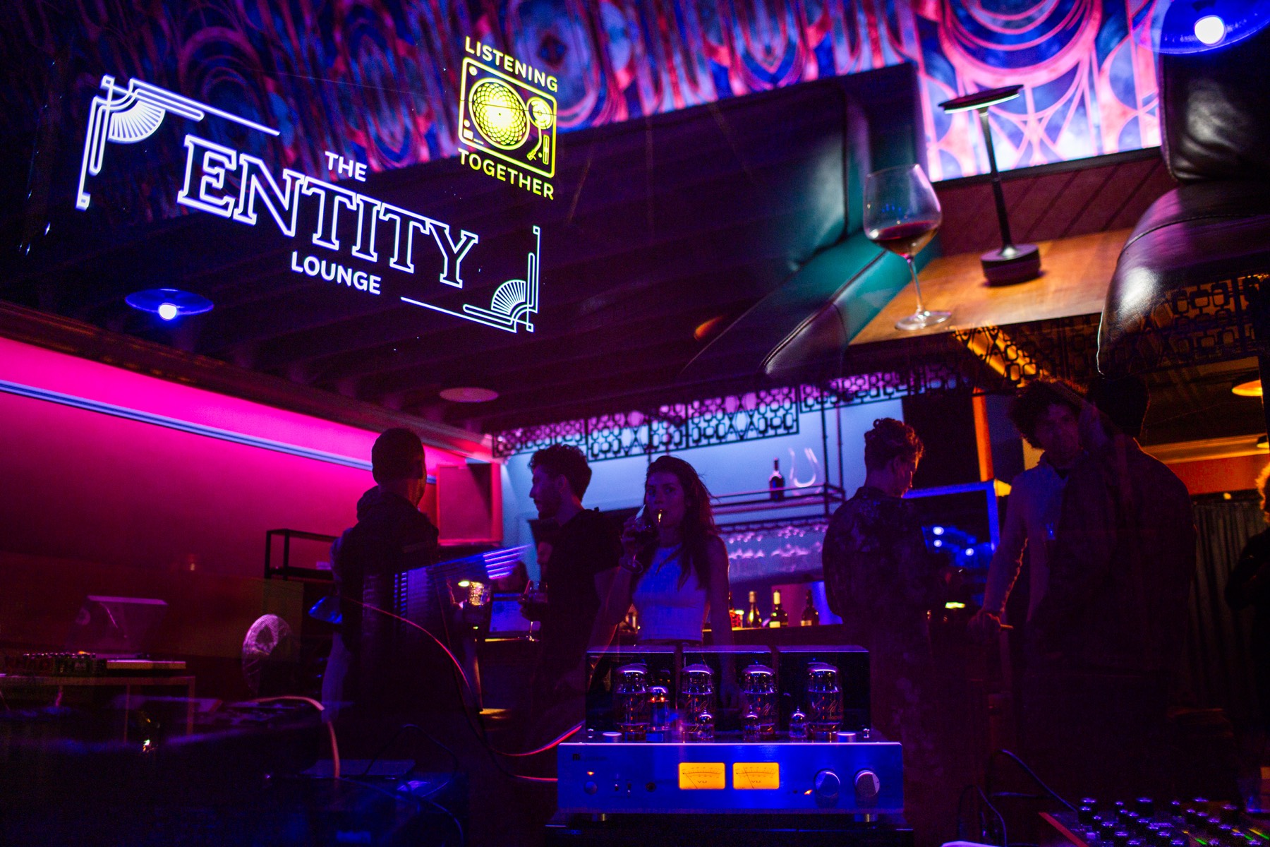 The lounge after dark under the neon Entity sign
