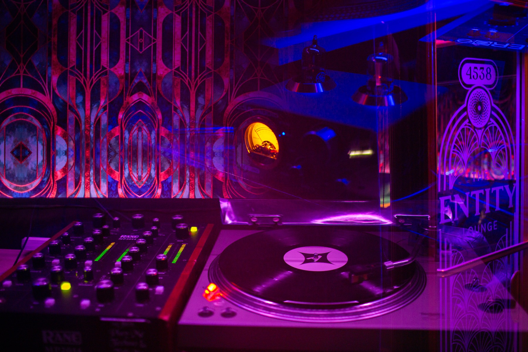 Turntable and mixer under magenta light