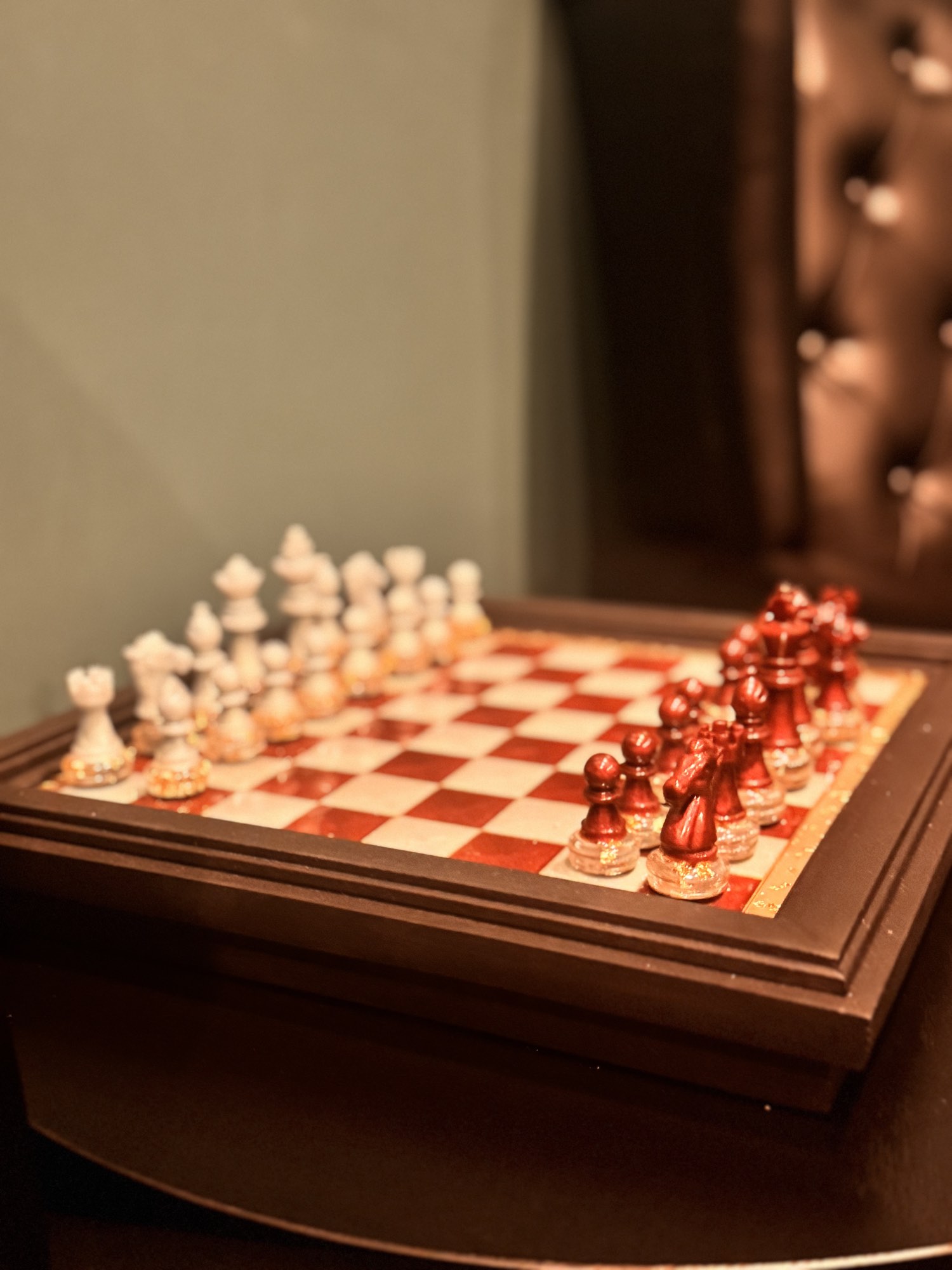 A red and white chess set on a table in the lounge
