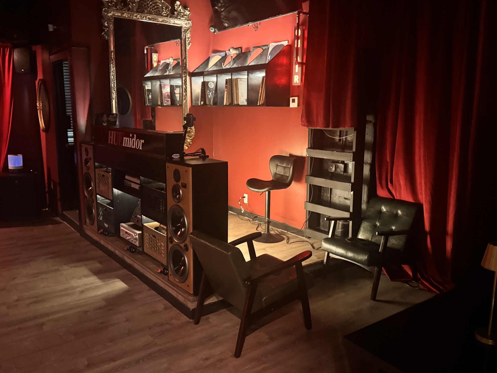 The listening corner with vintage speakers, a turntable and records on the wall