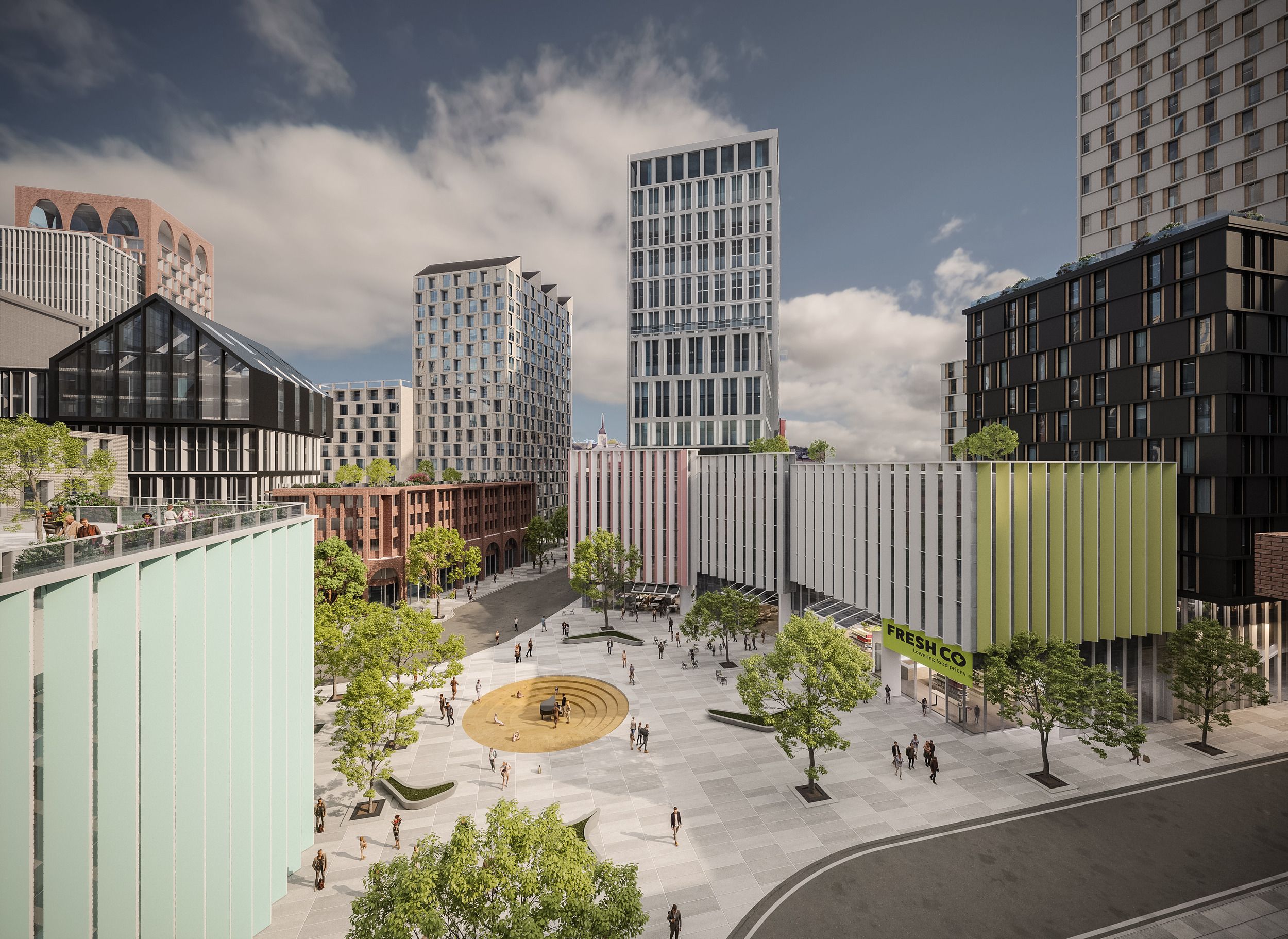 Modern urban development featuring mixed-use high-rise buildings surrounding a central public plaza with circular seating area and pedestrian walkways.