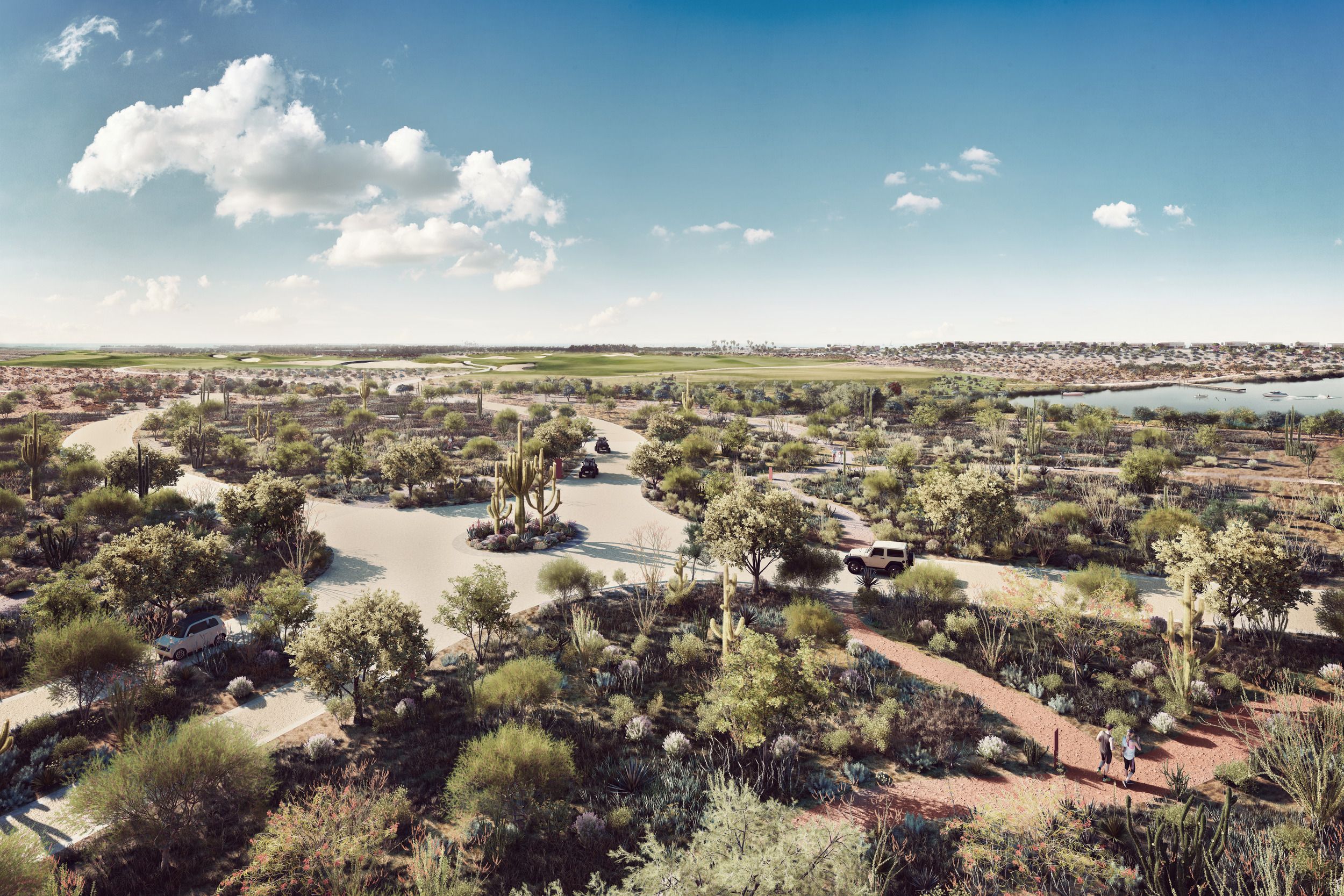 Aerial view of a desert botanical garden featuring winding paths, native cacti, and desert landscaping with a suburban development visible in the distance.