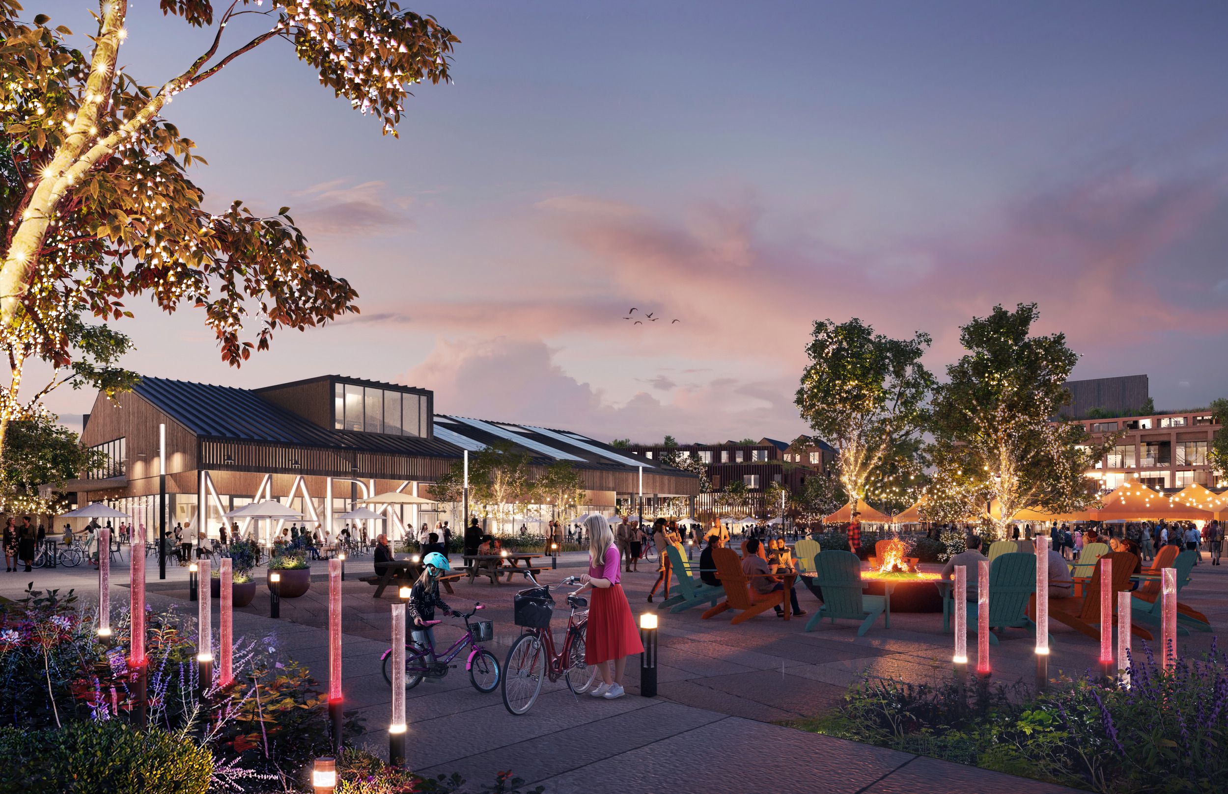 Architectural rendering of a vibrant community plaza featuring retail spaces, outdoor seating areas with fire pits, illuminated pathways, and gathering spaces at dusk.