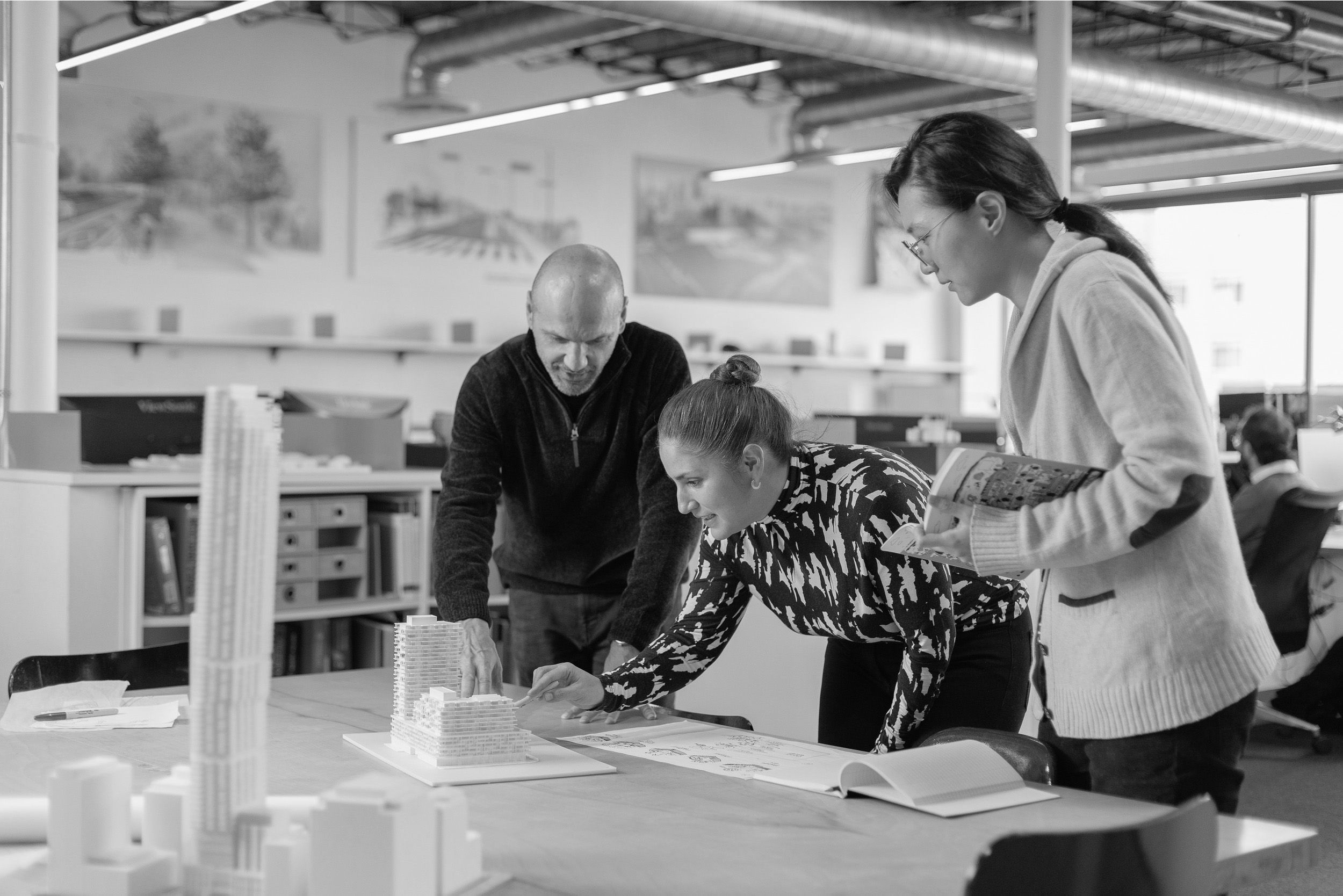 Our Toronto design team reviewing architectural model and drawings.