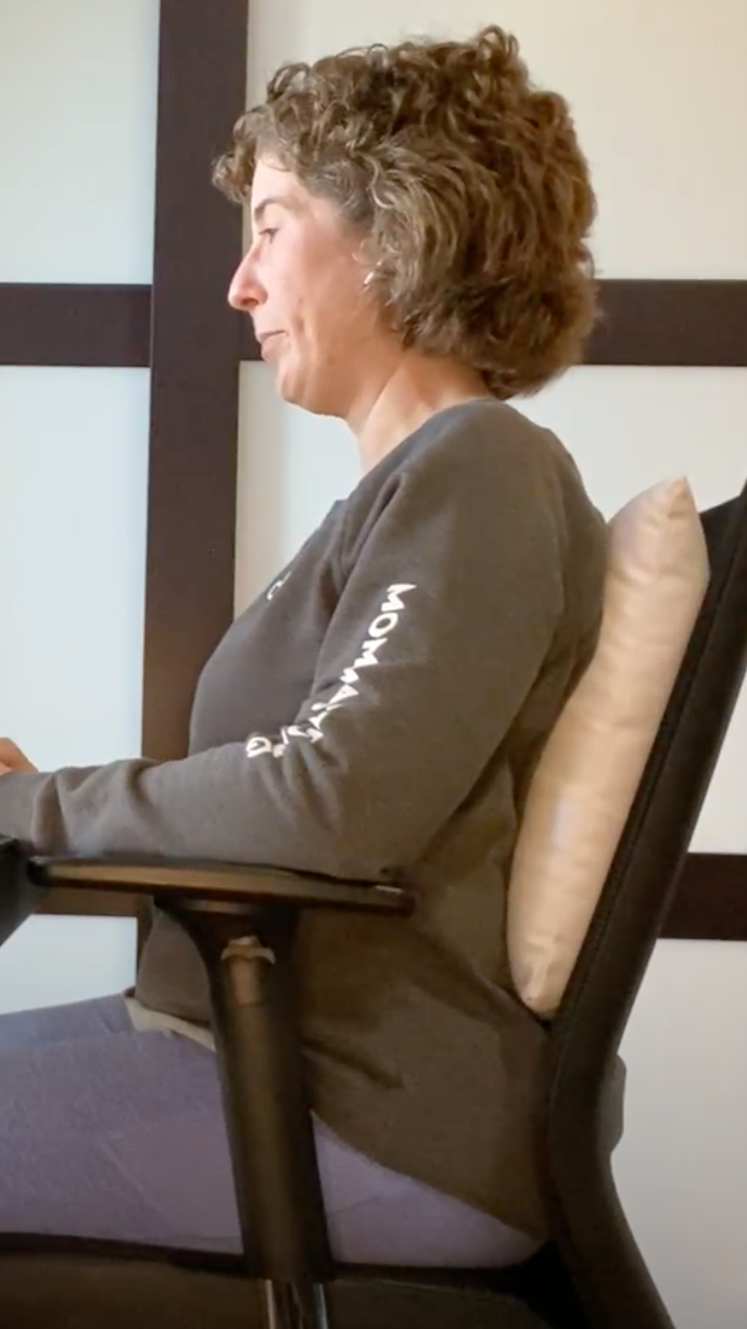 How can you avoid neck and back pain while sitting at your desk?