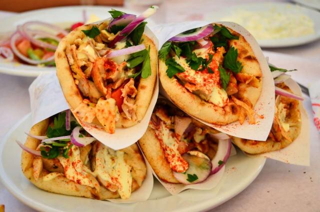High school students devour their gyros in Greece on their summer tour.