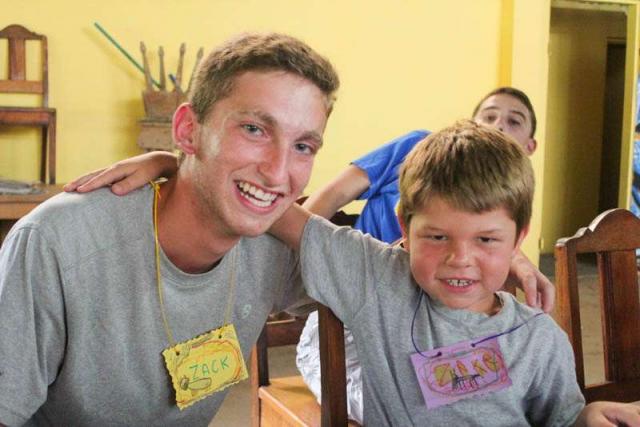 Teen boy makes a new friend during summer service program in Costa Rica.