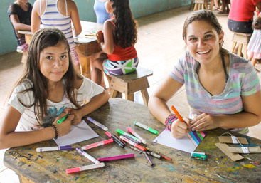 Teen spends time with local girls on community service summer program in Costa Rica.