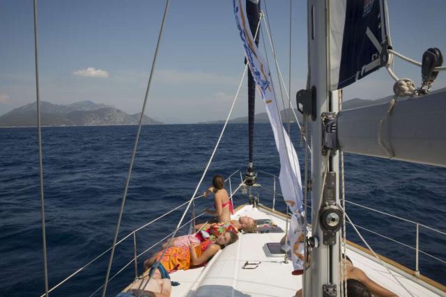 Teen traveler sails through Croatia islands in Adriatic Sea on summer adventure program
