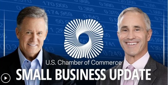 two men in suits smiling for a picture