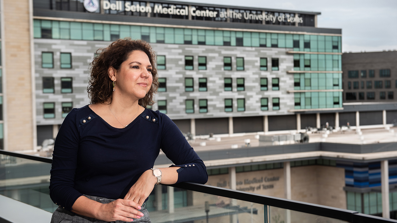 Brenda Garza stands on a balcony overlooking Dell Seton Medical Center.