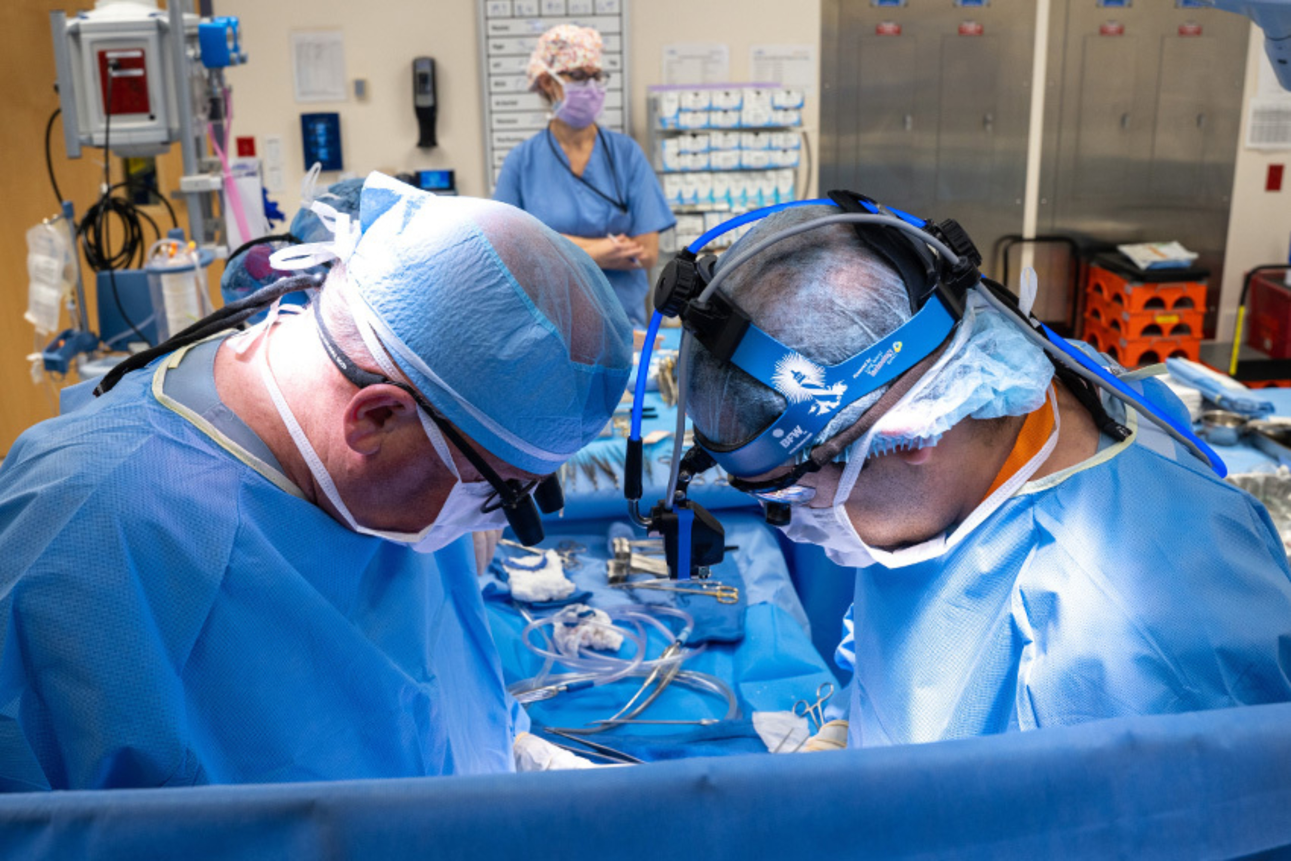 Two doctors performing pediatric heart surgery