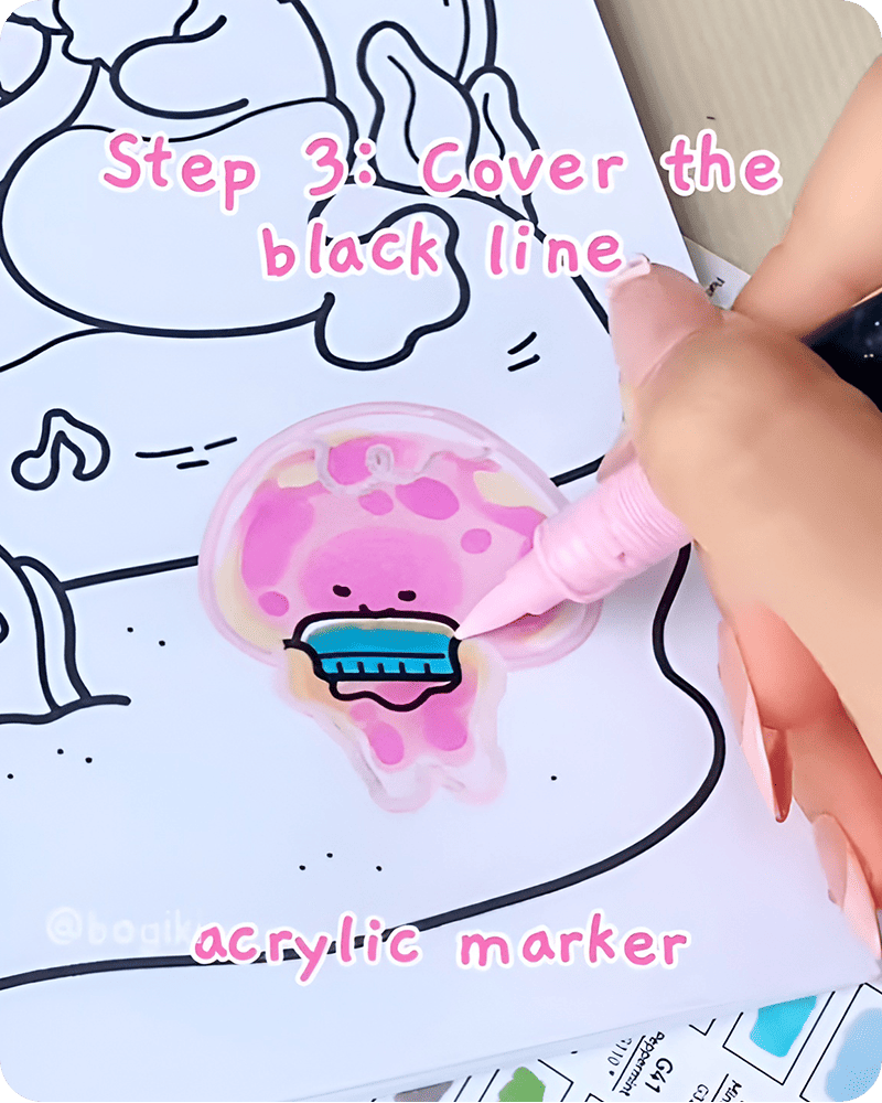 Covering black outlines with pink acrylic marker in how to draw a jellyfish step by step, softening edges to create a delicate and blended jellyfish form